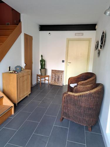 a living room with two chairs and a table at Chambres d'hôtes à 5min de Pairi Daiza et proche du SHAPE-OTAN in Lens