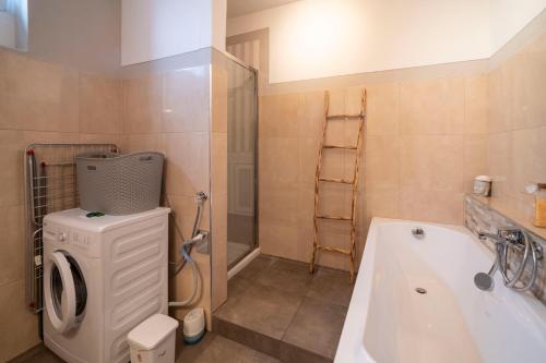 a bathroom with a washing machine and a sink at Mandala Maison - Zen Oasis in Marone