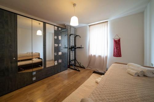 a bedroom with a bed and a large mirror at Mandala Maison - Zen Oasis in Marone
