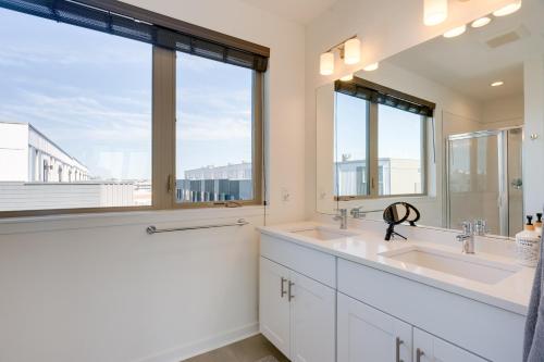 a bathroom with two sinks and a large window at Sleek Philadelphia Retreat with Private Rooftop in Philadelphia