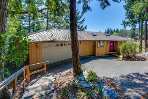 a house with a garage and a tree at Serene La Conner Retreat with Fireplace and Deck! in La Conner