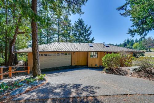 a house with a garage and a tree at Serene La Conner Retreat with Fireplace and Deck! in La Conner