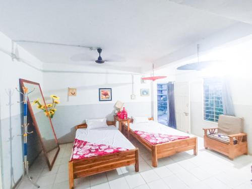 uma sala de estar com duas camas e uma cadeira em Budget tours&travels House em Dimāpur