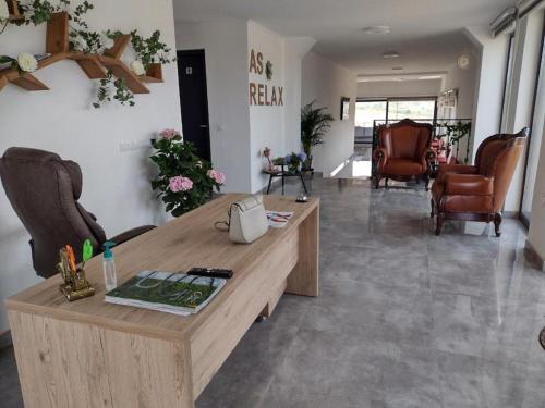 a living room with a wooden table and chairs at AS-Relax in Baile Felix