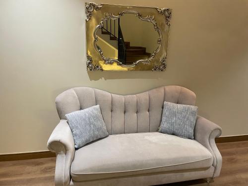 a couch in a living room with a mirror at Unique Home in Yanbu