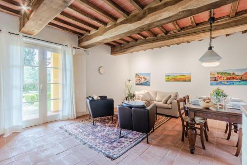 a living room with a table and a couch at Casa Lucchese al Borghetto in Collodi