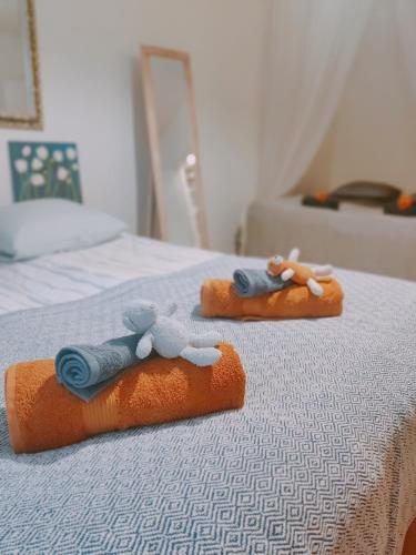 two stuffed animals sitting on top of a bed at Möysä beach apartment in Lahti