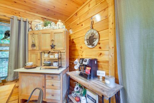 uma cozinha num chalé de madeira com um balcão e um micro-ondas em Family Cabin with Private Hot Tub and Game Room! em Sevierville