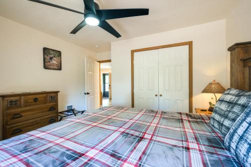 a bedroom with a bed and a ceiling fan at Spacious and Quiet Pagosa Springs Cabin with Deck! in Pagosa Springs