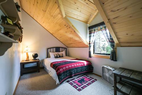 a bedroom with a bed and a wooden ceiling at Spacious and Quiet Pagosa Springs Cabin with Deck! in Pagosa Springs