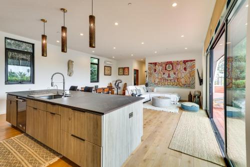 a kitchen with a sink and a living room at LA Nature Retreat with Rooftop Deck and Dtwn Views! in Los Angeles