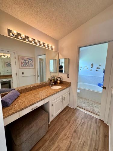 a bathroom with a sink and a large mirror at Private pool with a beautiful view overlooking the lake! Near Disney - Universal in Kissimmee