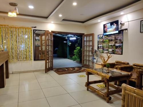 a living room with a table and a door at Sapphire luxury Suites in Ooty