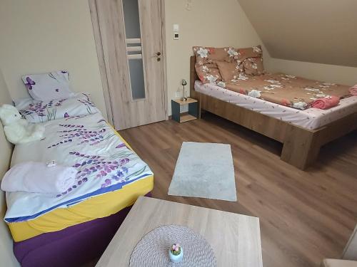 a room with a bed and a table and a couch at Holt-Tisza Vendégház in Szeged