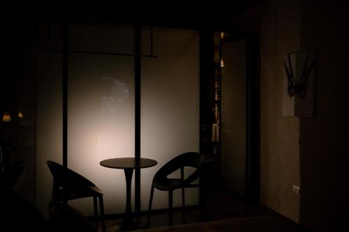 a table and a chair in a dark room at Fagus - Relax Suites in Faicchio