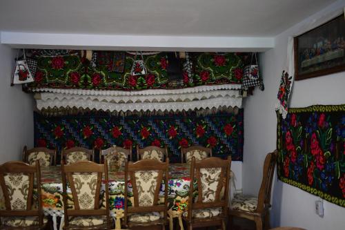 a room with a table and chairs and a curtain at Casa Vladicu in Breb