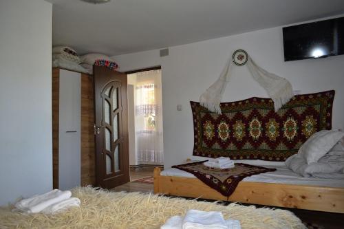 a bedroom with a bed and a window and a door at Casa Vladicu in Breb