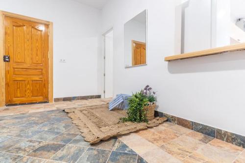 a room with a door and a rug and a plant at Casa rural Acueducto in Almería
