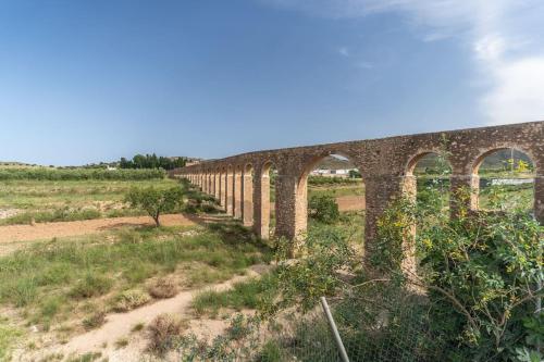 an old bridge in the middle of a field at Casa rural Acueducto in Almería