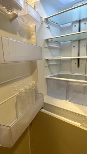 an empty refrigerator with bottles of water in it at Elbon The beach Haeundae in Busan