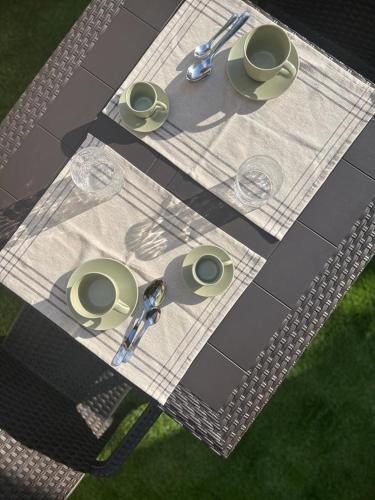 a picnic table with plates and glasses on it at Residenze Romavi in Ascea