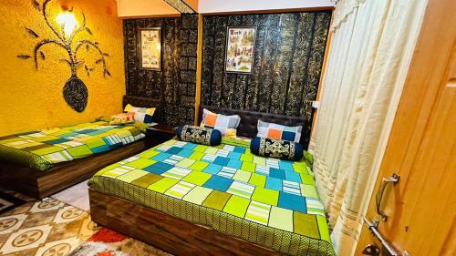 a bedroom with two beds in a room at MAMTA HOMESTAY in Darjeeling