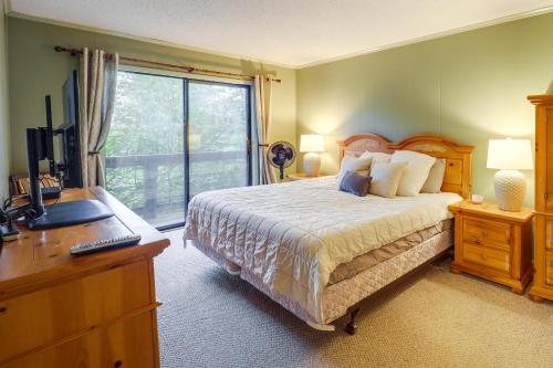 a bedroom with a bed and a desk and a television at Walk to Slopes! Pet-Friendly Beech Mtn Condo in Beech Mountain