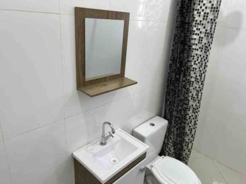 a bathroom with a sink and a toilet and a mirror at Estudio na Vila Guilherme Ao lado Expo Center Norte in São Paulo