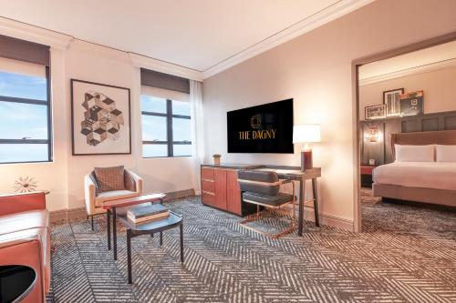 a hotel room with a bed and a desk at The Dagny Boston in Boston