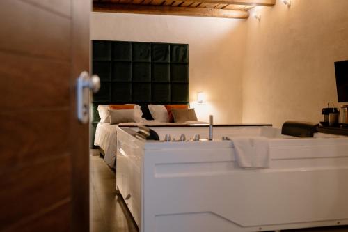a bedroom with a bed with a sink and a mirror at Fagus - Relax Suites in Faicchio