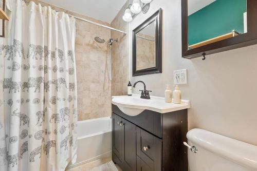 a bathroom with a sink and a shower curtain at Charming 4 Bedroom Home W/ Large, Gated Backyard in Los Angeles
