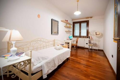 a bedroom with a bed and a table and a desk at La Via per Tharros in Oristano