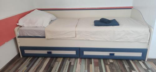 a small bed with two drawers and a hat on it at Inessa center budget room in Chişinău