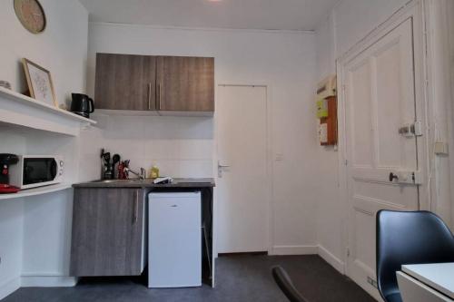 une petite cuisine avec un comptoir et un réfrigérateur dans l'établissement Chez K&D Studio Jaune Le Havre, au Havre