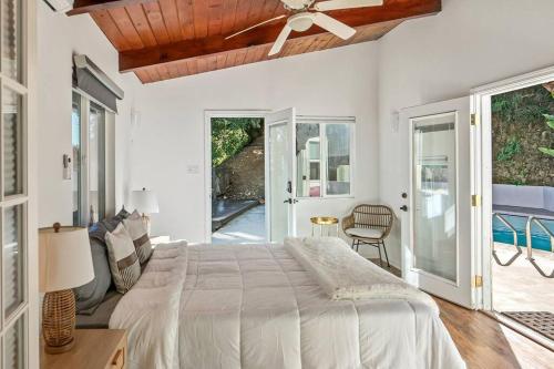 a bedroom with a bed and a ceiling fan at Hillside Canyon, Private Home W/ Pool and Nature in Los Angeles