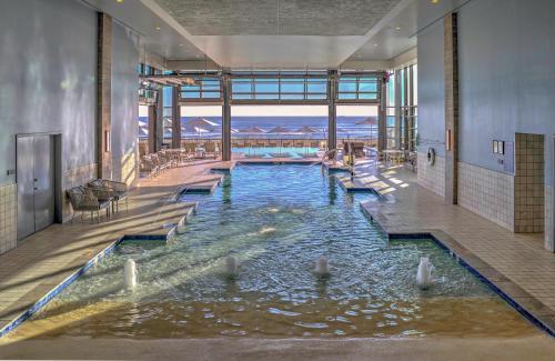 a large swimming pool with people sitting in it at Marriott Virginia Beach Oceanfront Resort in Virginia Beach