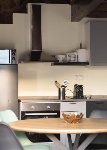 a kitchen with a wooden table and a counter top at Ecolagar O Barqueiro in Pantón