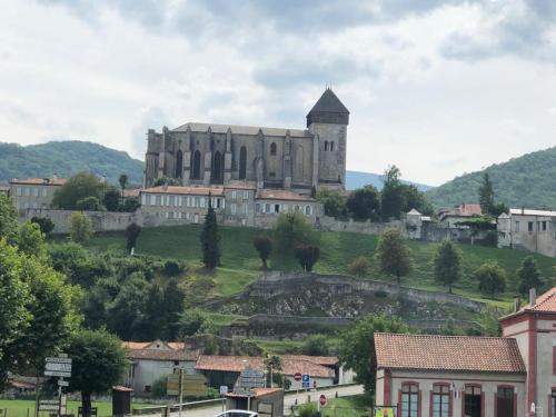 a large castle on top of a hill at Appartement Familial in Marignac