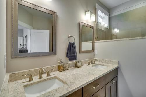 a bathroom with two sinks and a mirror at Secluded Barboursville Home with Covered Porch! in Barboursville