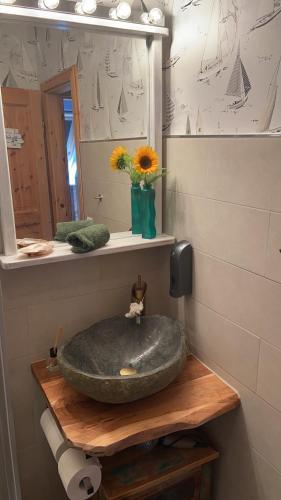 a bathroom with a stone sink and a mirror at Ferienhaus „Schöne Aussicht“ in Hasselberg