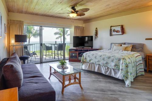 a bedroom with a bed and a tv and a couch at Sunny Waianae Condo with Ocean View! in Waianae