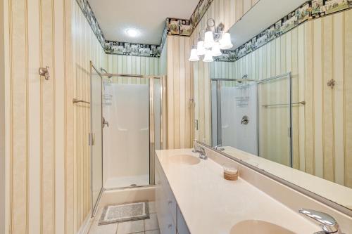 a bathroom with a shower and a sink and a mirror at Myrtle Beach Condo with Community Perks in Myrtle Beach