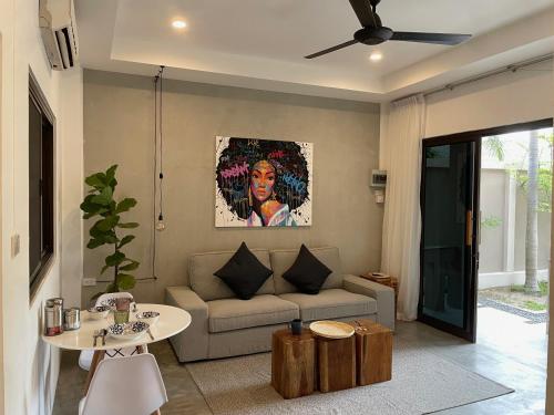 a living room with a couch and a table at PATAMAAN COTTAGES in Nathon Bay