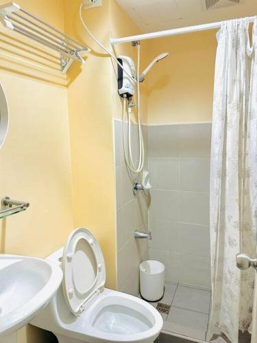 a bathroom with a shower and a toilet and a sink at Avida Riala Cebu: Your Home in Cebu City