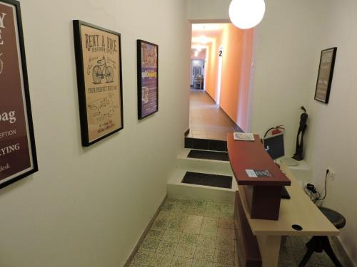 a hallway with stairs and a sign on the wall at Hostel Marina Trogir in Trogir