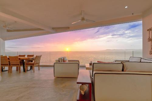 a living room with a view of the ocean at Maxwell Residences at Indah in Puerto Vallarta