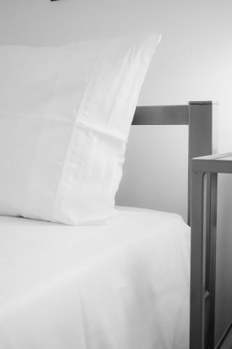 a black and white photo of a bed with a curtain at Alexandra's Place in Galatás