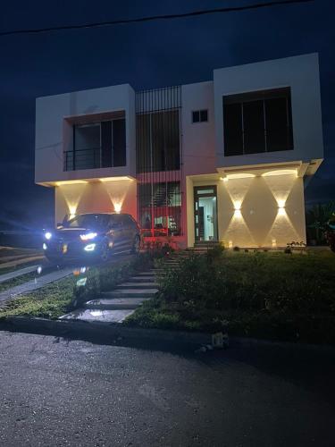a car parked in front of a building at night at Casa quinta Aluna in Carmen de Apicalá