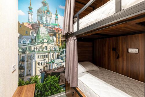 a bedroom with a view of the city at MISTO capsule hotel in Kyiv