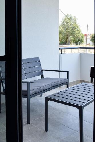 a bench sitting on top of a balcony at Alexandra's Place in Galatás